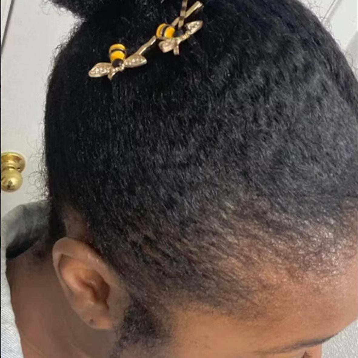 Close-up of a person's hair with decorative hairpins.