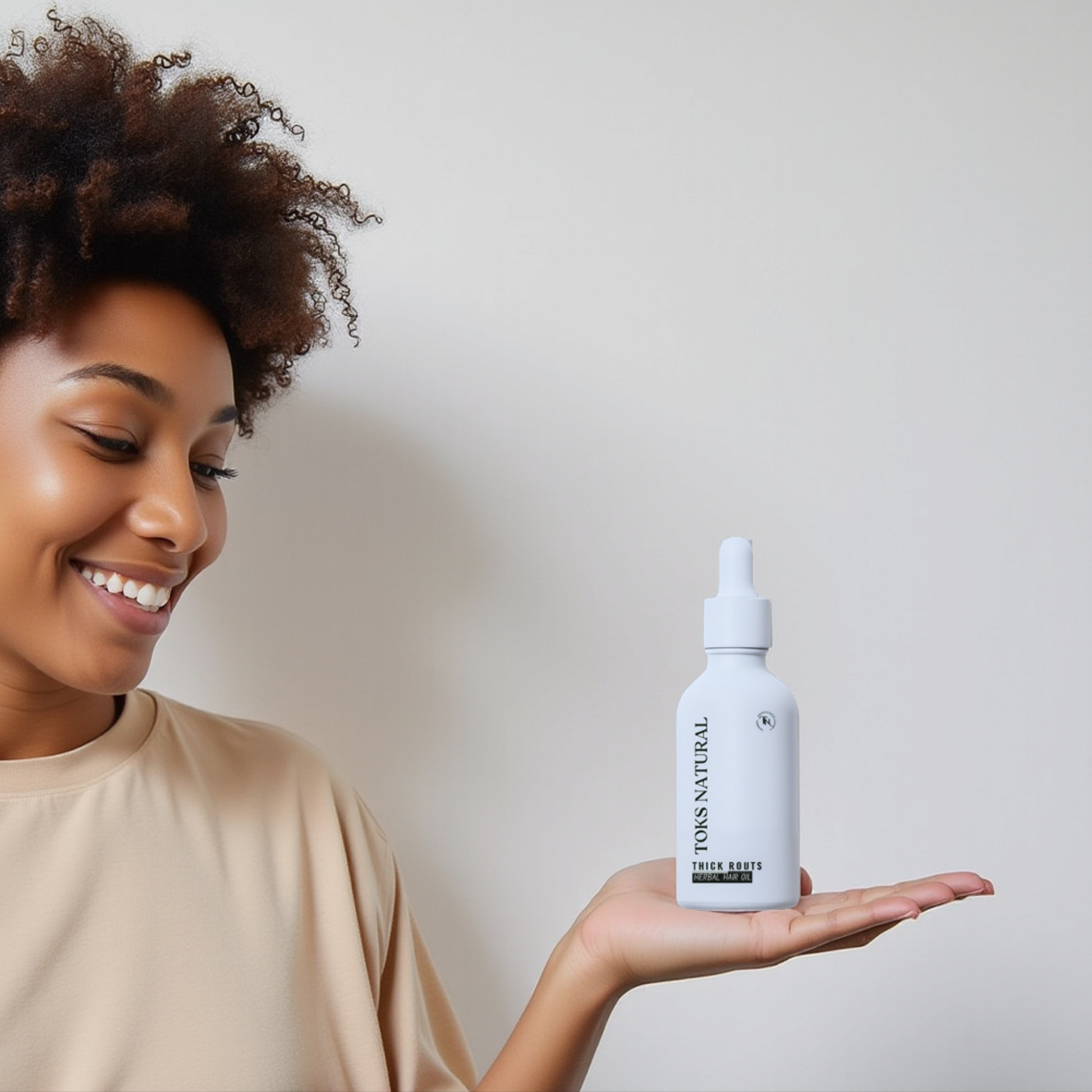 lady holding thick roots oil bottle