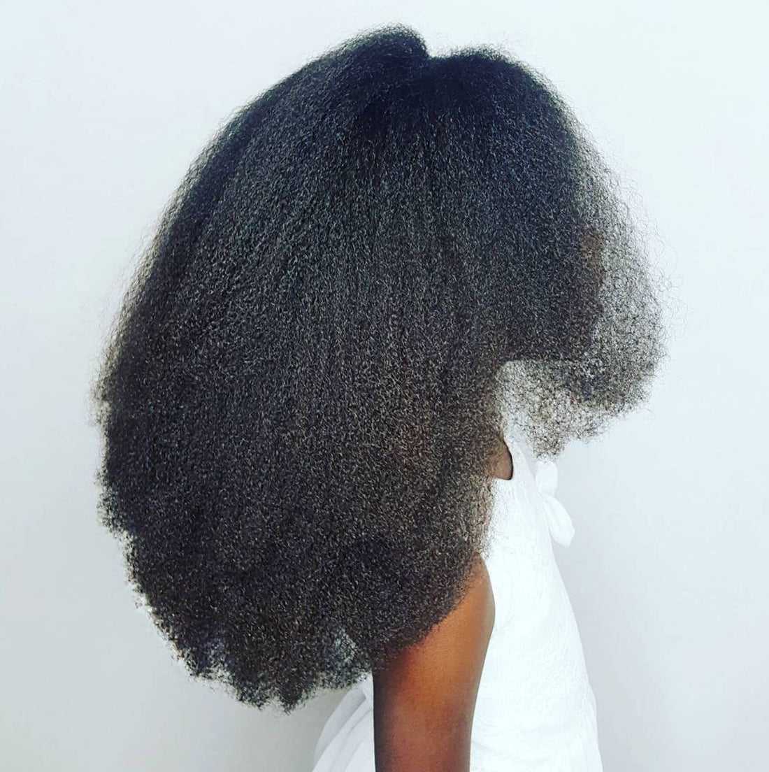 Natural hair growth journey with nourishing and protective styles.