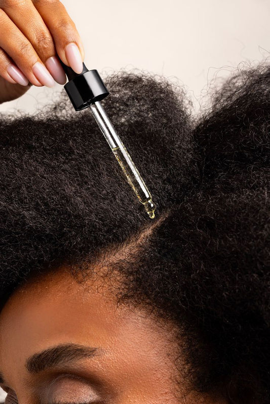 lady applying oil to scalp