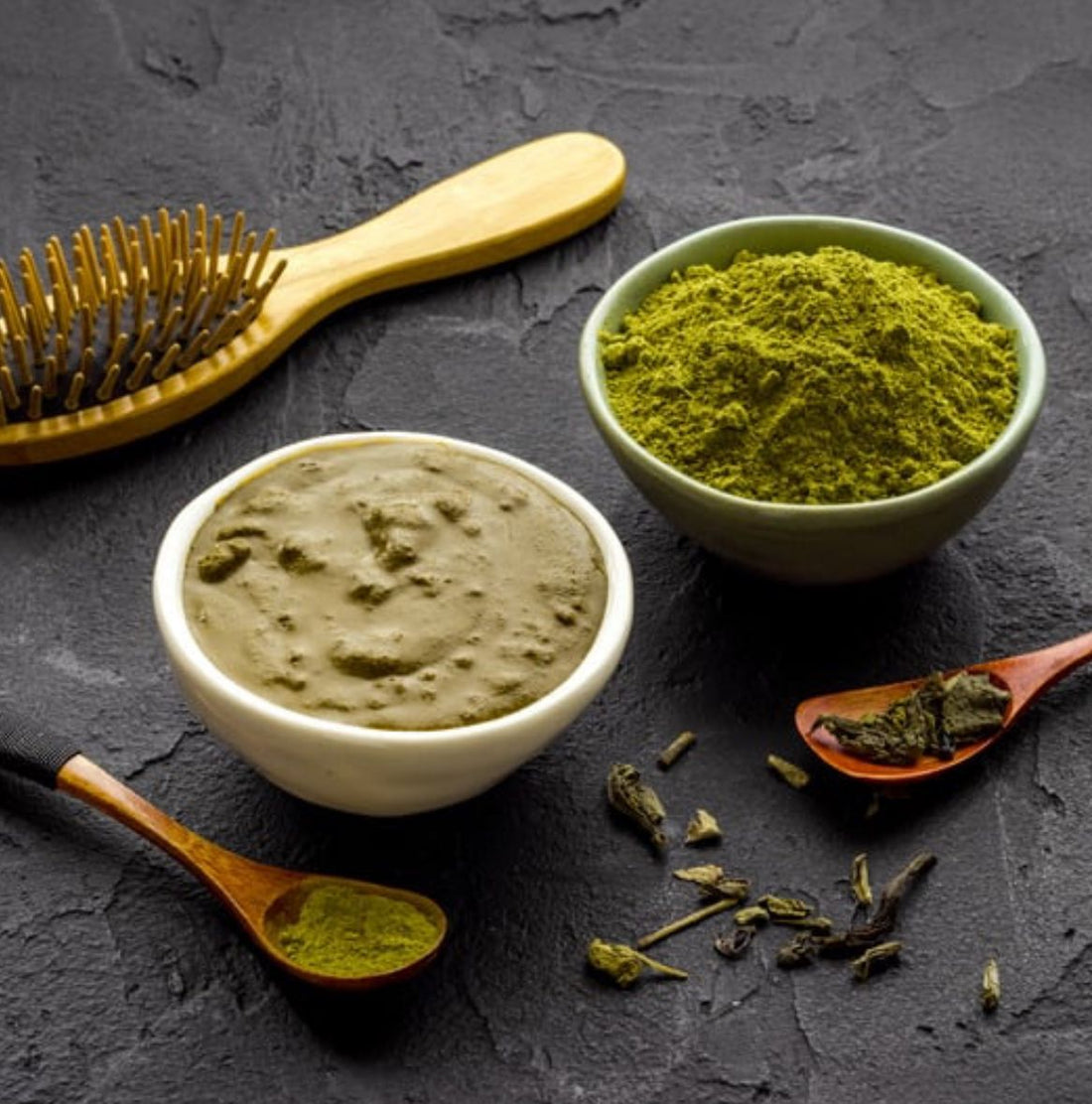 Indigo powder and henna powder with a bowl for mixing to achieve a rich brown or black shade.