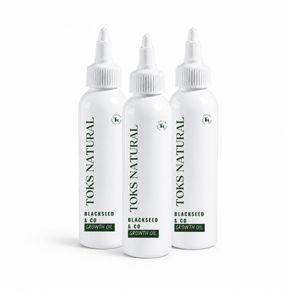 Three bottles of Toks Natural Blackseed & Co Growth Oil on a white background