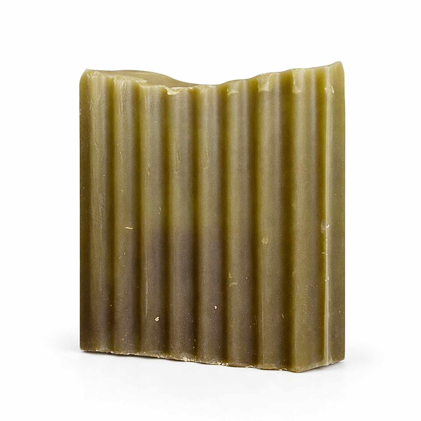 Bar of soap with a ribbed texture on a white background
