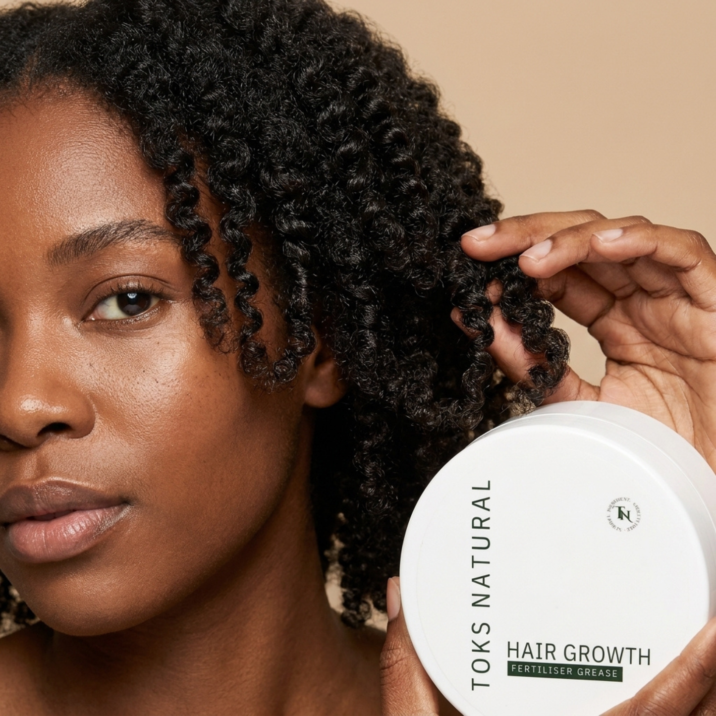 Woman with styled hair holding a container of Toks Natural Hair Growth product.
