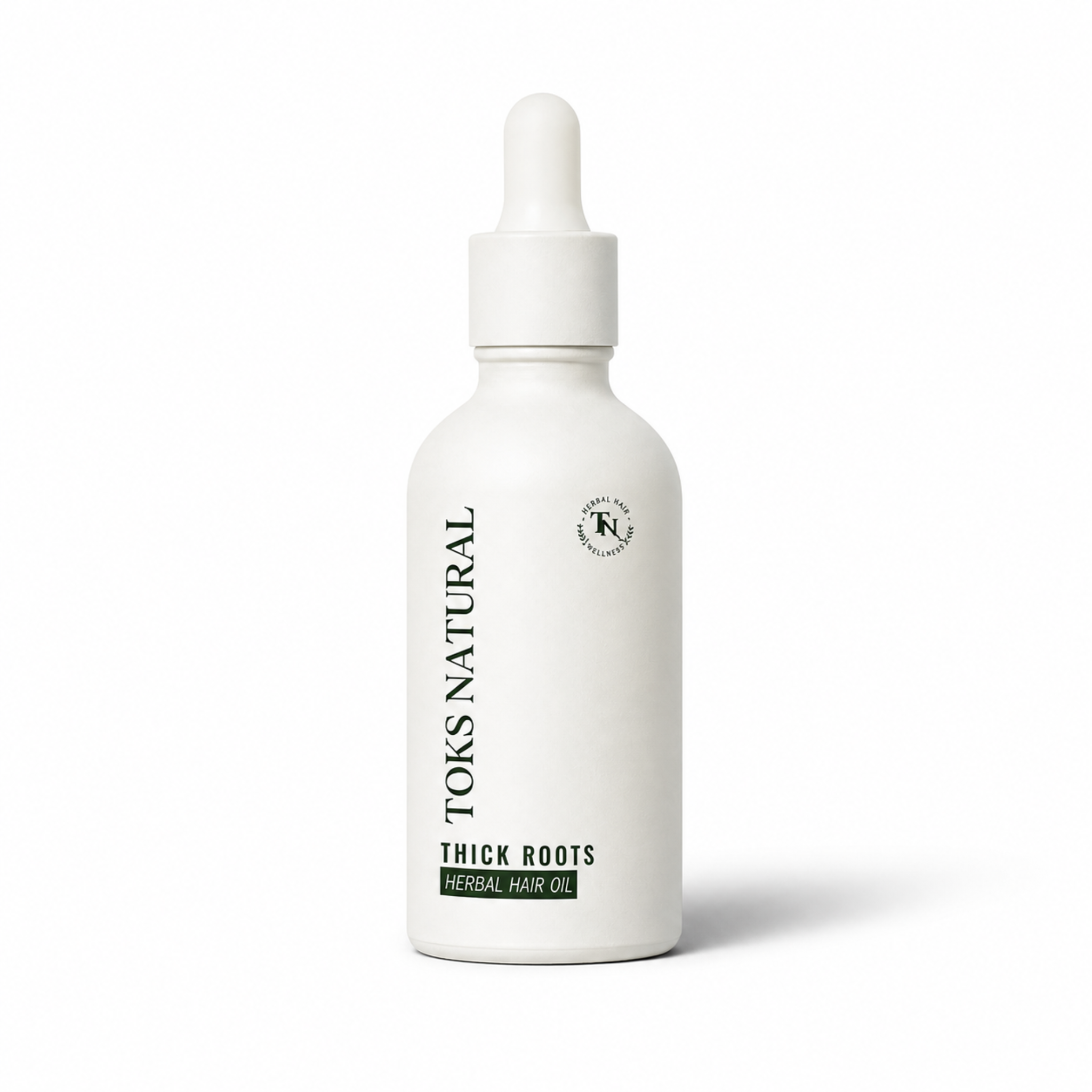 White bottle of Toks Natural Thick Roots Herbal Hair Oil on a white background