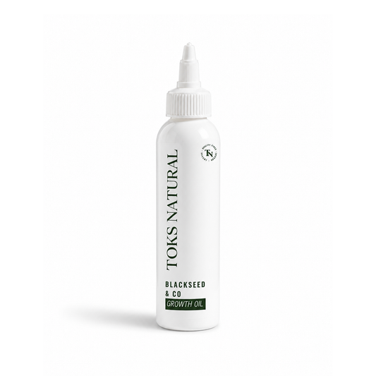 White bottle of Toks Natural Blackseed & Co oil on a white background