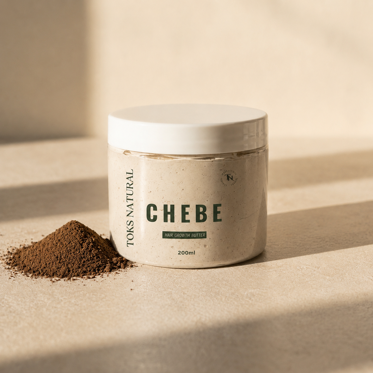 Jar of TOKS NATURAL CHEBE hair growth butter with a pile of powder on a beige background