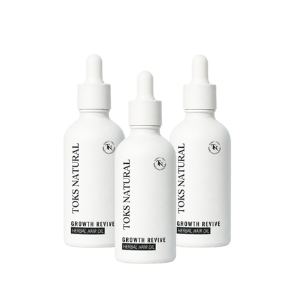 Three bottles of Toks Natural Growth Revive Herbal Hair Oil on a white background