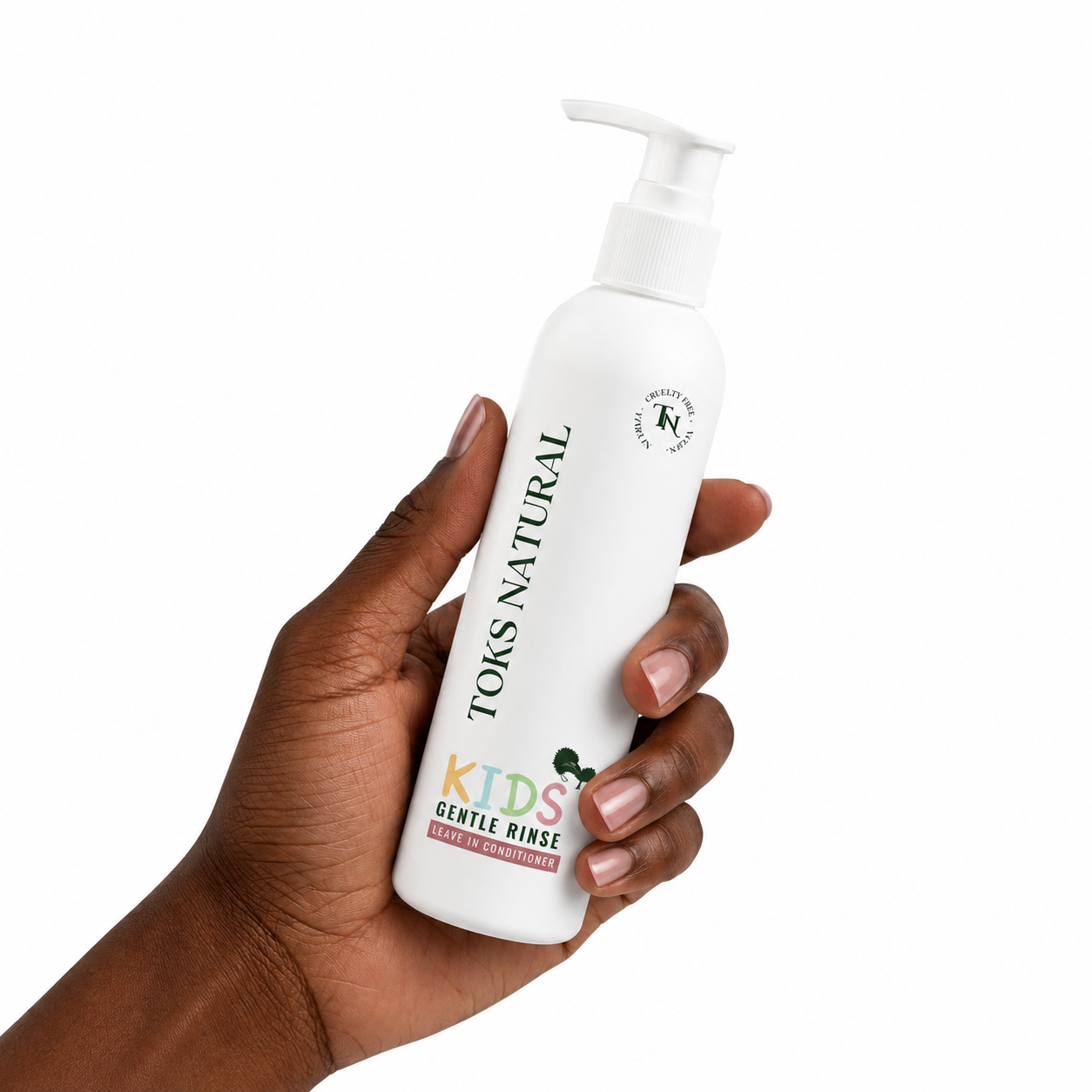 Hand holding a bottle of 'Toks Natural Kids Gentle Rinse' on a white background