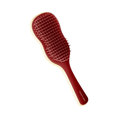 Red paddle hairbrush on a white background