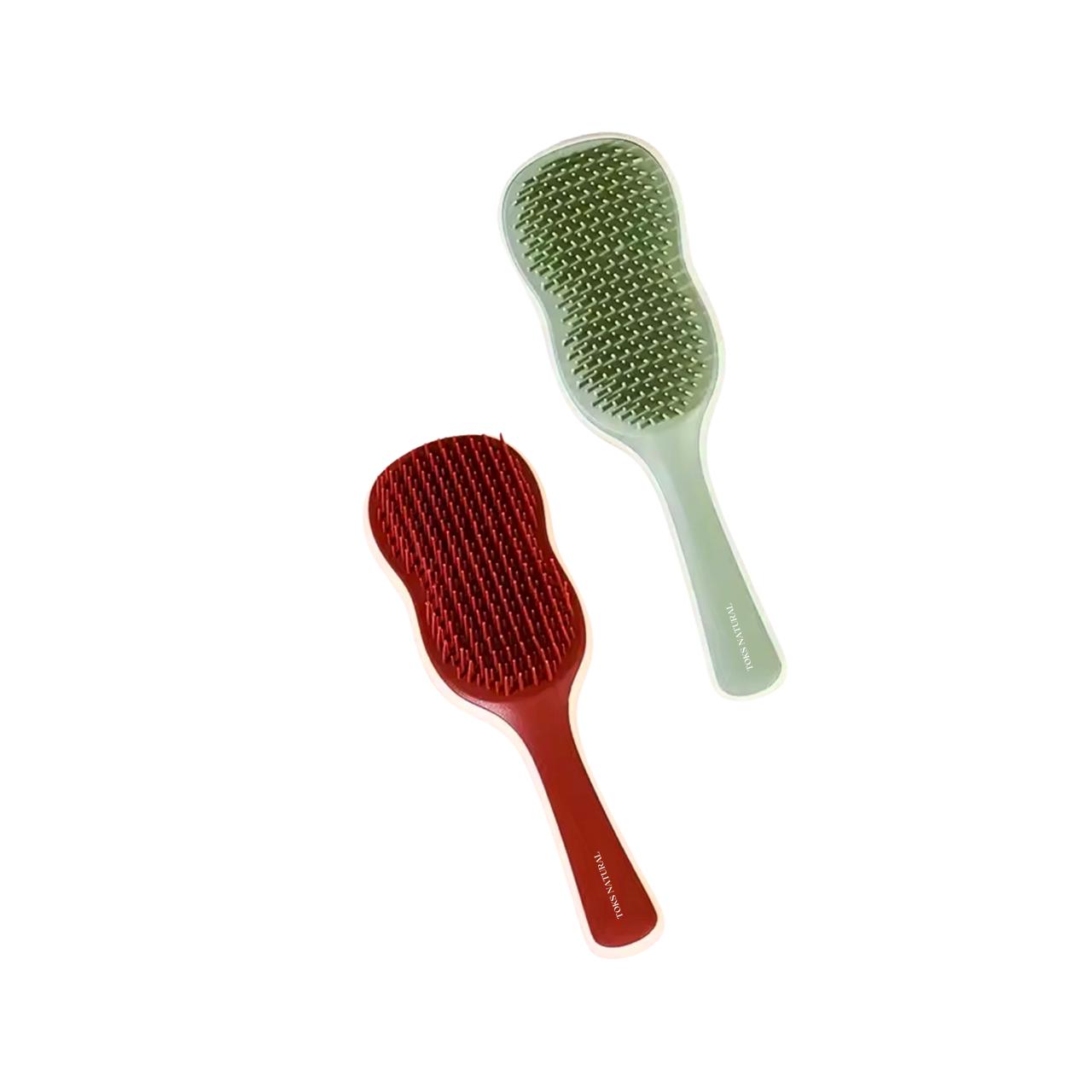 Red and green hairbrushes on a white background