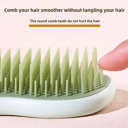 Hair comb with round teeth being held by a hand on a light pink background