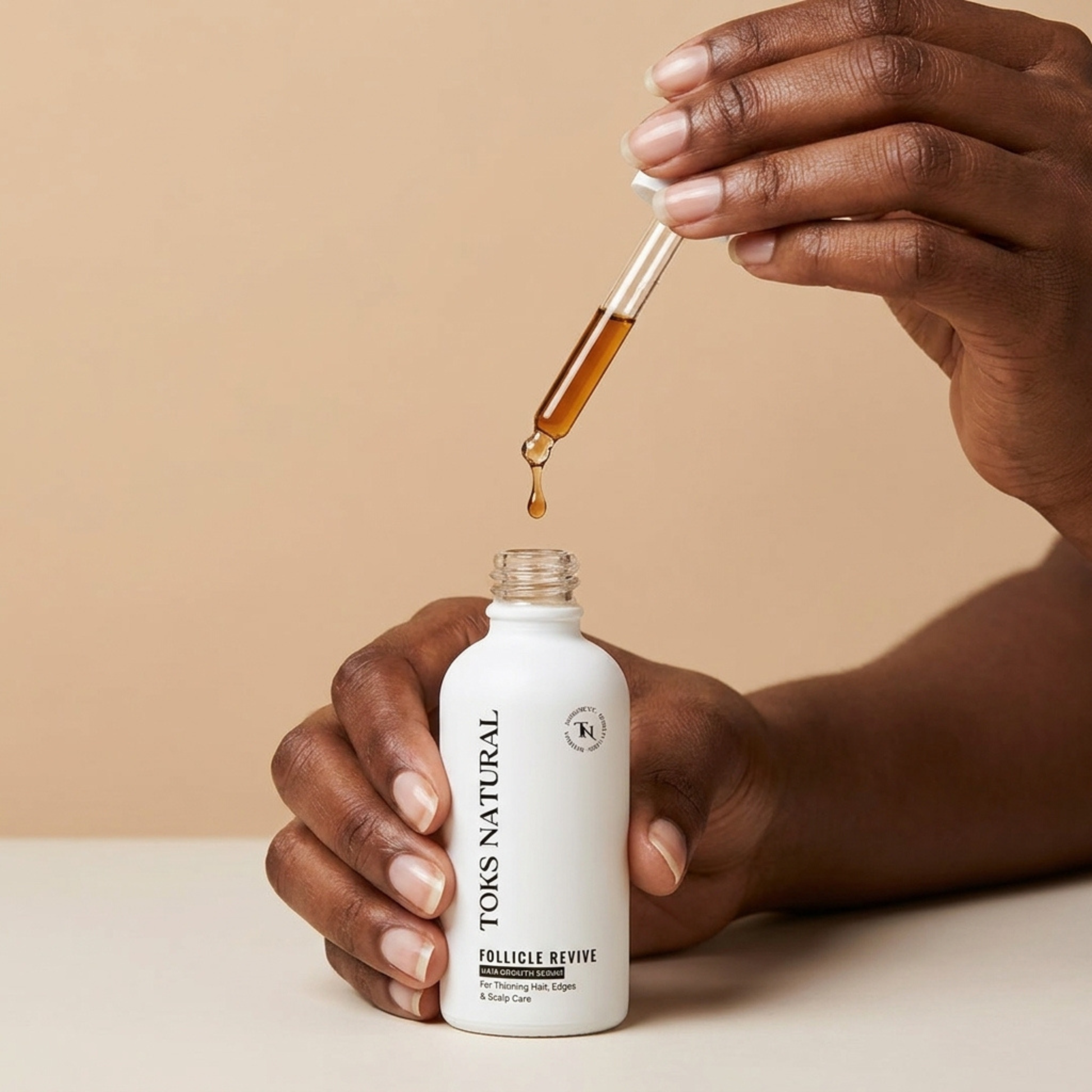 Hand holding a bottle of TONS NATURAL follicle revive product with a dropper.