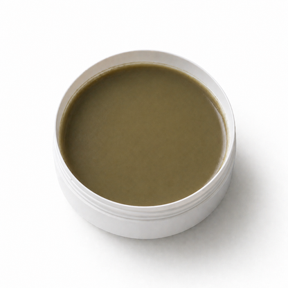 White container with brownish-green substance on a white background