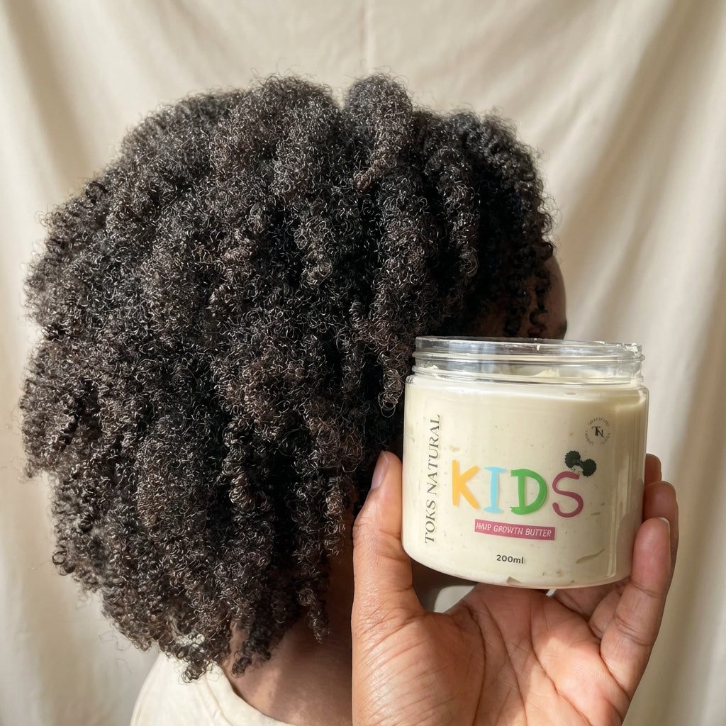Person holding a jar of 'Kids' hair product with curly hair against a neutral background