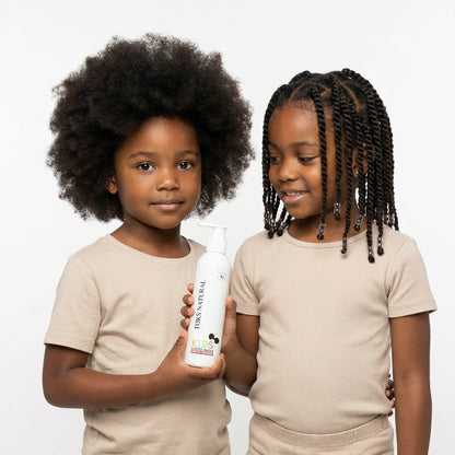 Two children holding a bottle of 'Dr. X' product against a white background