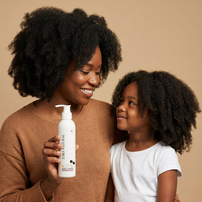 Woman and child holding a bottle of Tokes Naturals product against a beige background