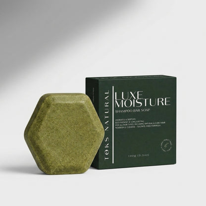 toks natural green shampoo bar next to its packaging on a gray background