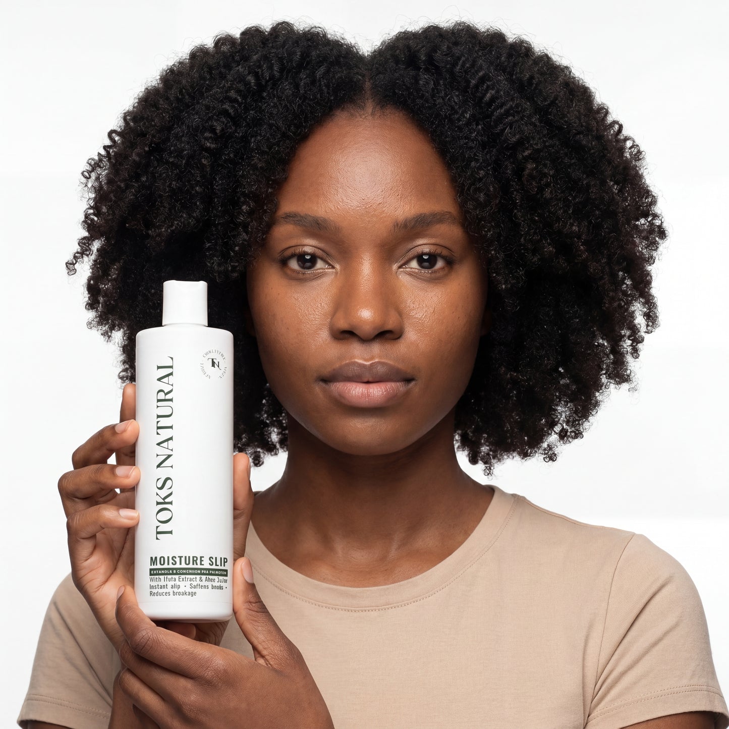 Woman holding a bottle of 'TOKS NATURAL' product against a white background
