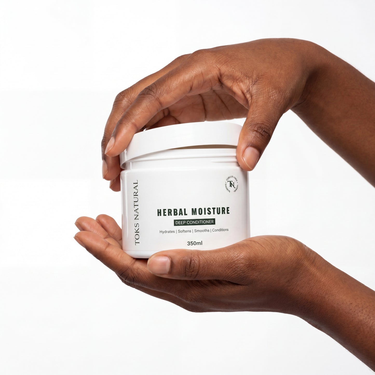 Hand holding a jar of 'Herbal Moisture' deep conditioner with a white background
