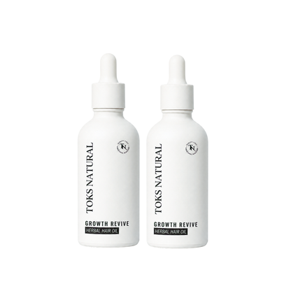 Two bottles of Toks Natural Growth Revive Herbal Hair Oil on a white background