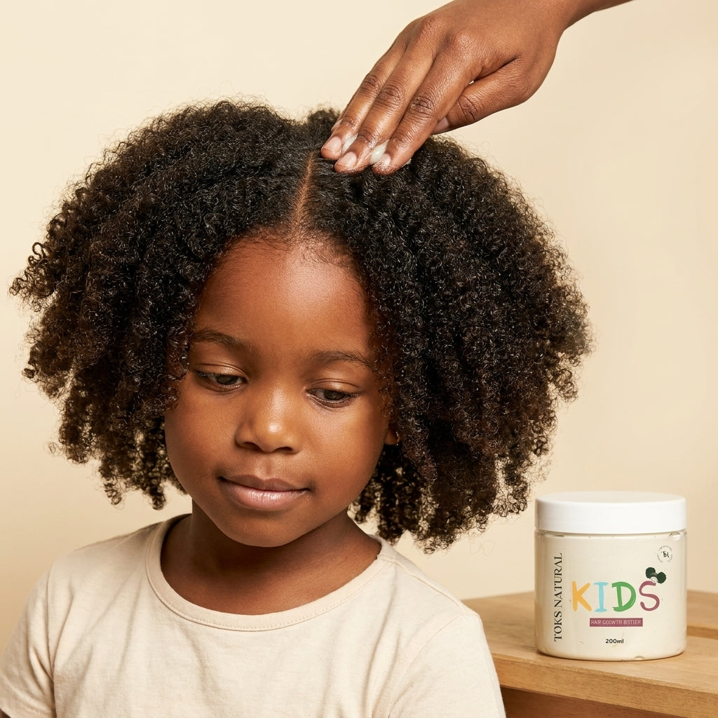 Child with curly hair being touched by a hand, with a jar of product on a shelf in the background.