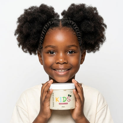 kid wearing a white shirt and holding hair growth butter