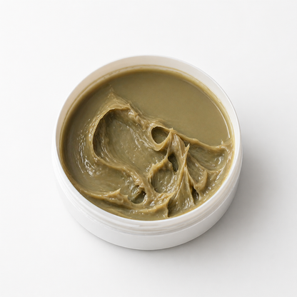 White container with greenish-brown paste on a white background
